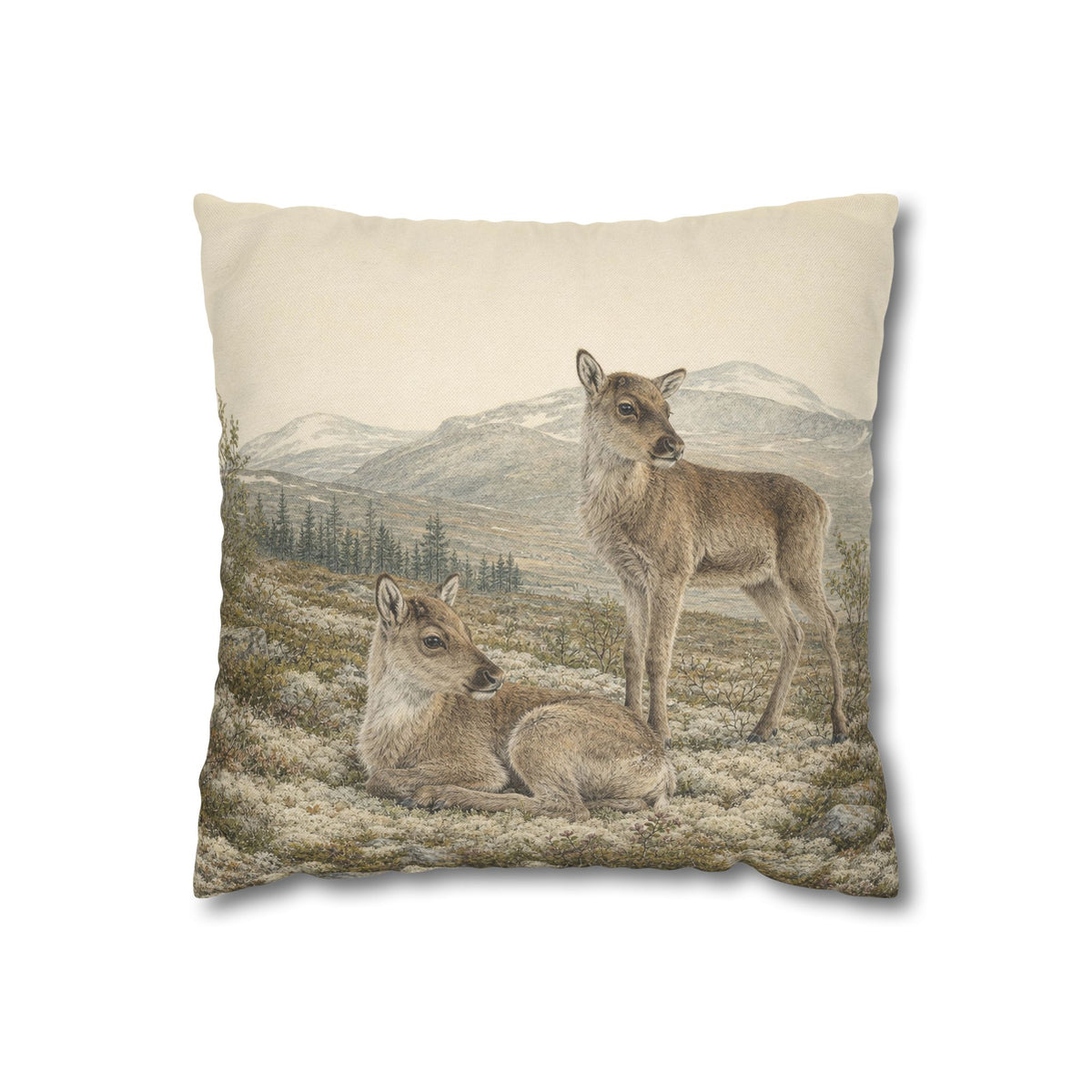 Mountain wildlife pillow cover with resting and standing reindeer calves, distant mountains and natural tundra landscape, displayed in a rustic Scandinavian home interior.